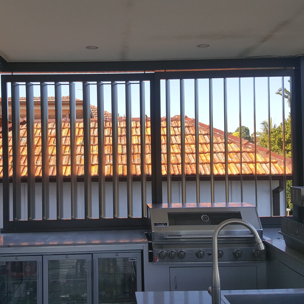 Aluminium 160mm privacy screen louvres in outdoor BBQ area, dark grey vertical blades, Sydney