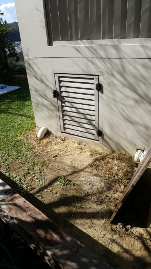 louver door for access under a house with a lock
