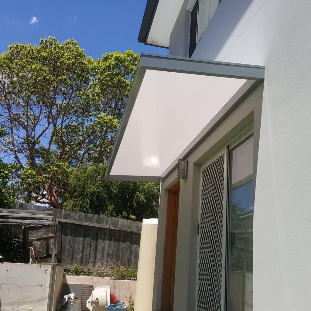 Concealed bracket awning Sydney – white Slimline 100 spanning a sliding door and adjacent side window for full rain and weather protection