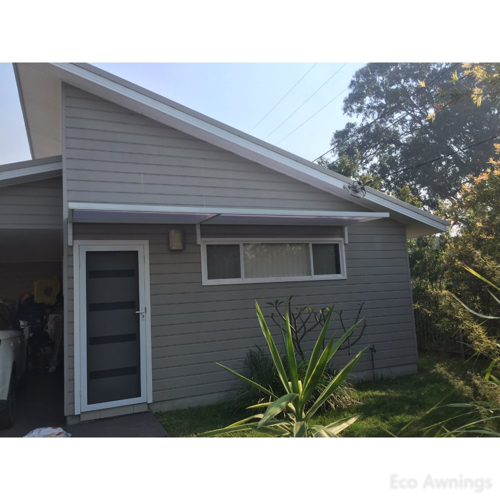 Slimline 50 polycarbonate window and door awning spanning a front door and window on a Sydney home